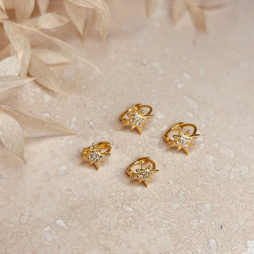 Set de 2 pares de aros huggie de estrella dorados con cristales