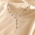 Set de collar de piedras de colores en oro blanco