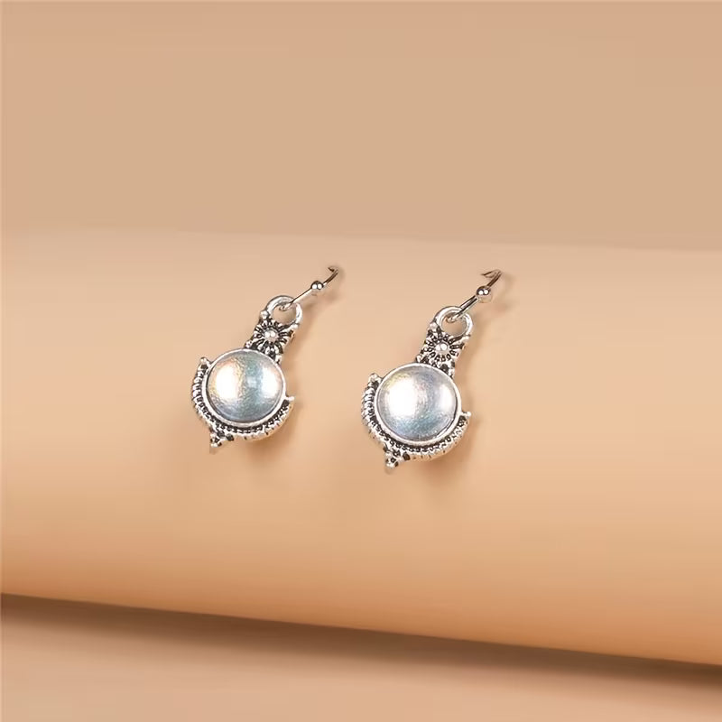 Pendientes elegantes de piedra de luna redonda en cabujón