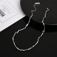 Collar de torsión ondulada en oro blanco – imagen 2