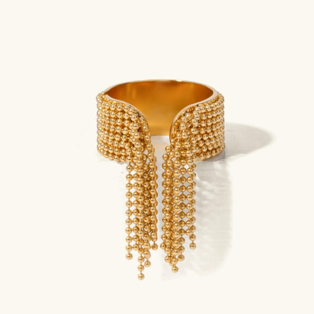 Anillo radiante con borla dorada