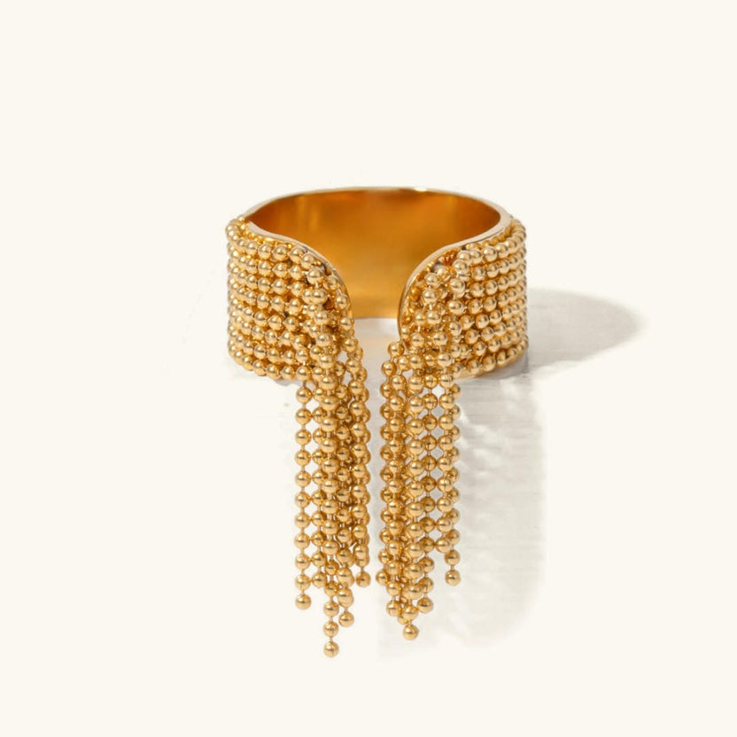 Anillo radiante con borla dorada