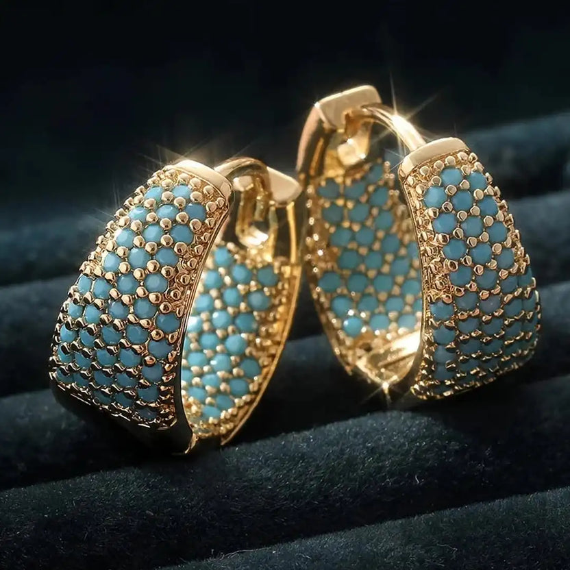 Pendientes de aro adornados con turquesa y flores doradas