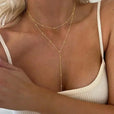 Collar largo de doble capa con borlas y cuentas doradas