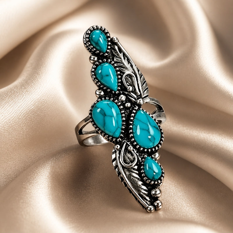 Anillo llamativo de turquesa con plumas