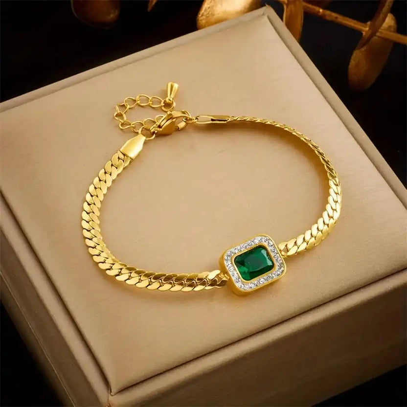 Pulsera radiante de eslabones dorados con esmeralda