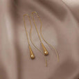 Pendientes dorados de borla en forma de gota
