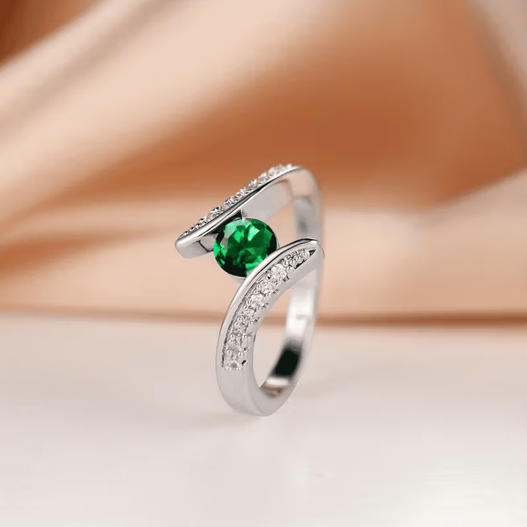 Anillo llamativo esmeralda con brillo orbital