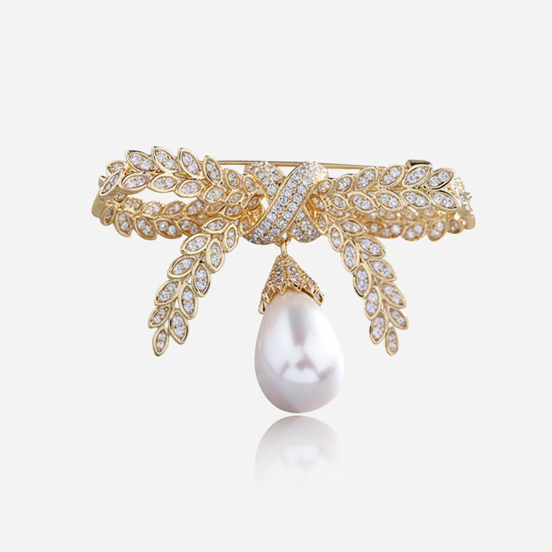 Broche de lazo con perlas colgantes